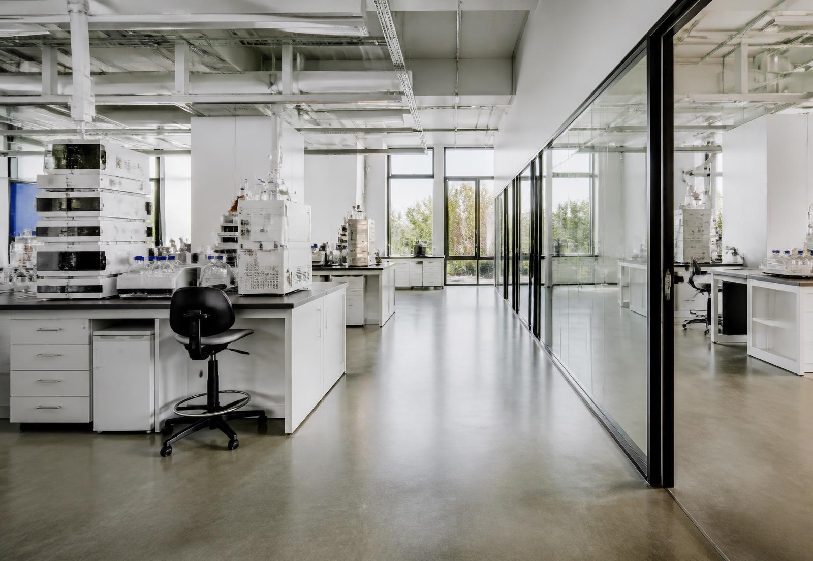 Interior of a bright modern research facility with laboratory benches and glazed partitions
